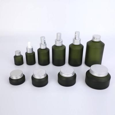 Cuidado de la piel verde hombro inclinado vasos botellas frascos conjuntos