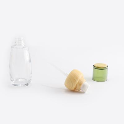juego de botellas de vidrio cosmético transparente con tapa de bambú
