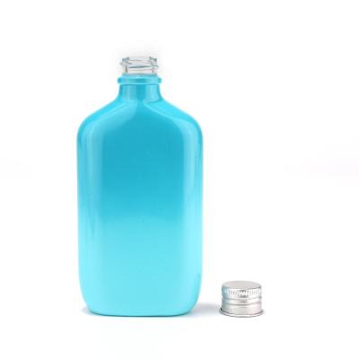Botella de vidrio de color personalizado de nuevo diseño con bomba de pulverización para cosméticos
