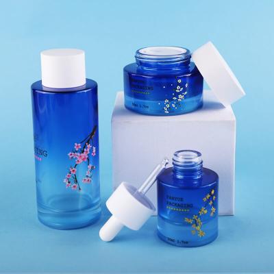 Conjunto de botella de vidrio de hombro plano azul degradado de alta calidad Embalaje