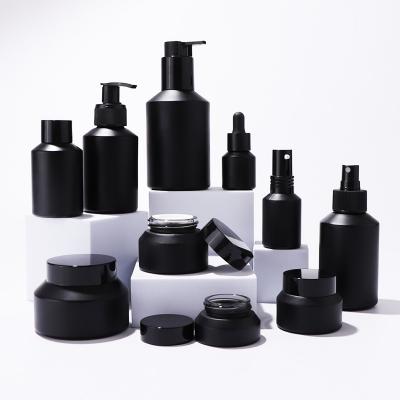 Frascos y frascos de vidrio negro mate para empaques para el cuidado de la piel