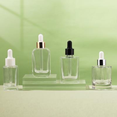 Los frascos cuentagotas de esencia de vidrio transparente se pueden personalizar con forma redonda y cuadrada
        