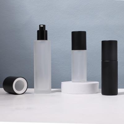 Botella de vidrio con bomba redonda de 50 ml y 100 ml para embalaje de loción cosmética